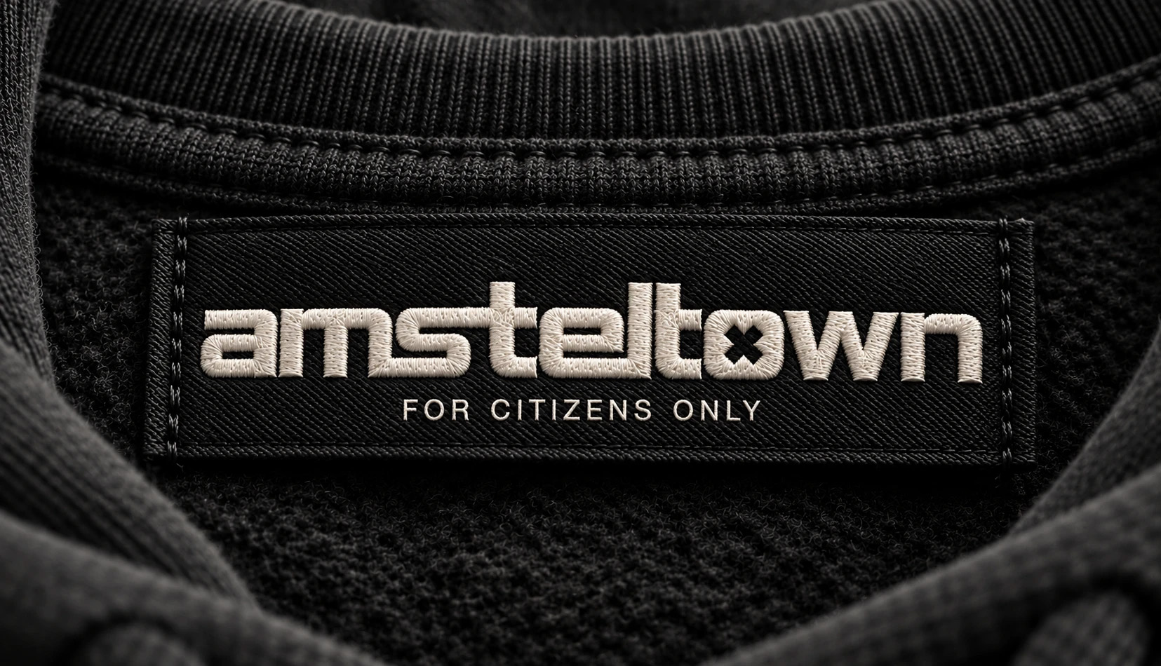 Black amsteltown neck label with the embroidered wordmark and FOR CITIZENS ONLY